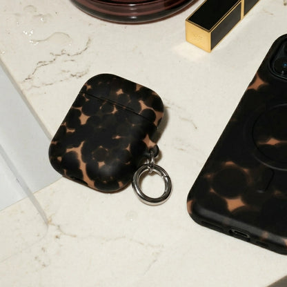 Phone case, air pod case, and lipstick on a marble surface